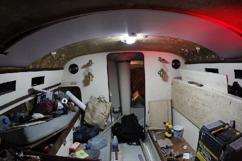 What a mess. First bit of insulation up on the roof. One or two sheets a night