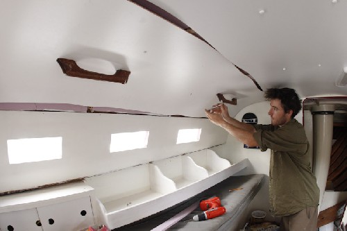 Installing the lovely white ceiling - starting to ook clean down below!