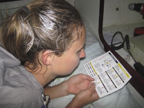 White hair from the stress of all-day painting, Jess tries to stay awake in bed learning the rules of yachting