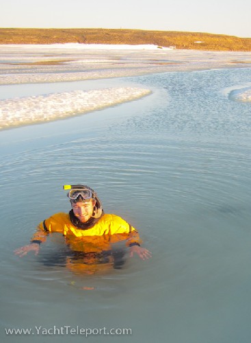 Chris ice swimming in a seal hole