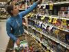 Jess trying to pick the lesser of various evils of tinned SPAM to stock up on - Click for full-size.