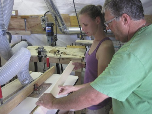 Terry showing Jess how to round edges of wood on a router